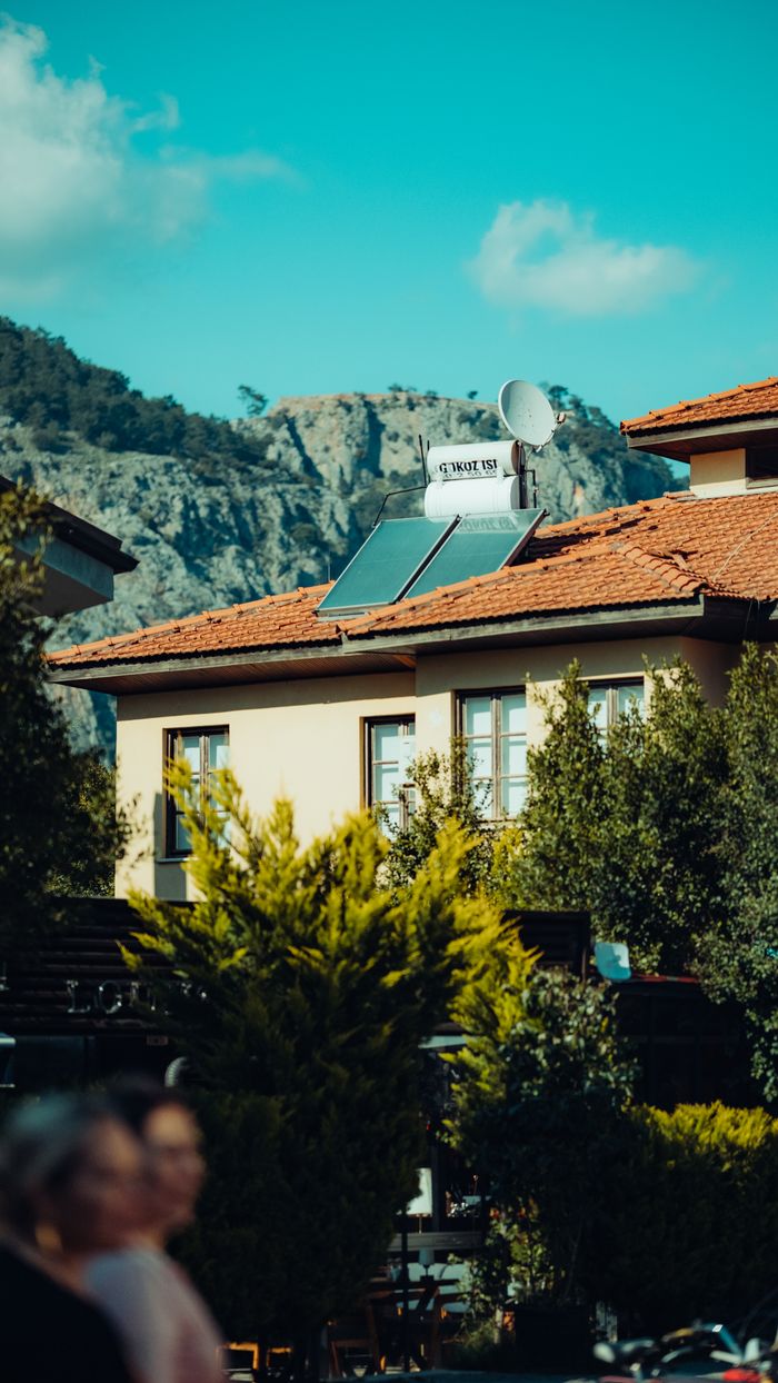 gallery-3 A picturesque urban house with solar panels and mountain view in the background.