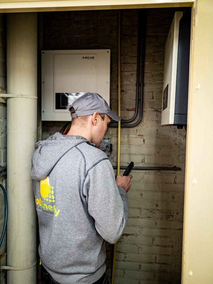 services-img A technician examines solar power installations indoors, ensuring optimal performance.